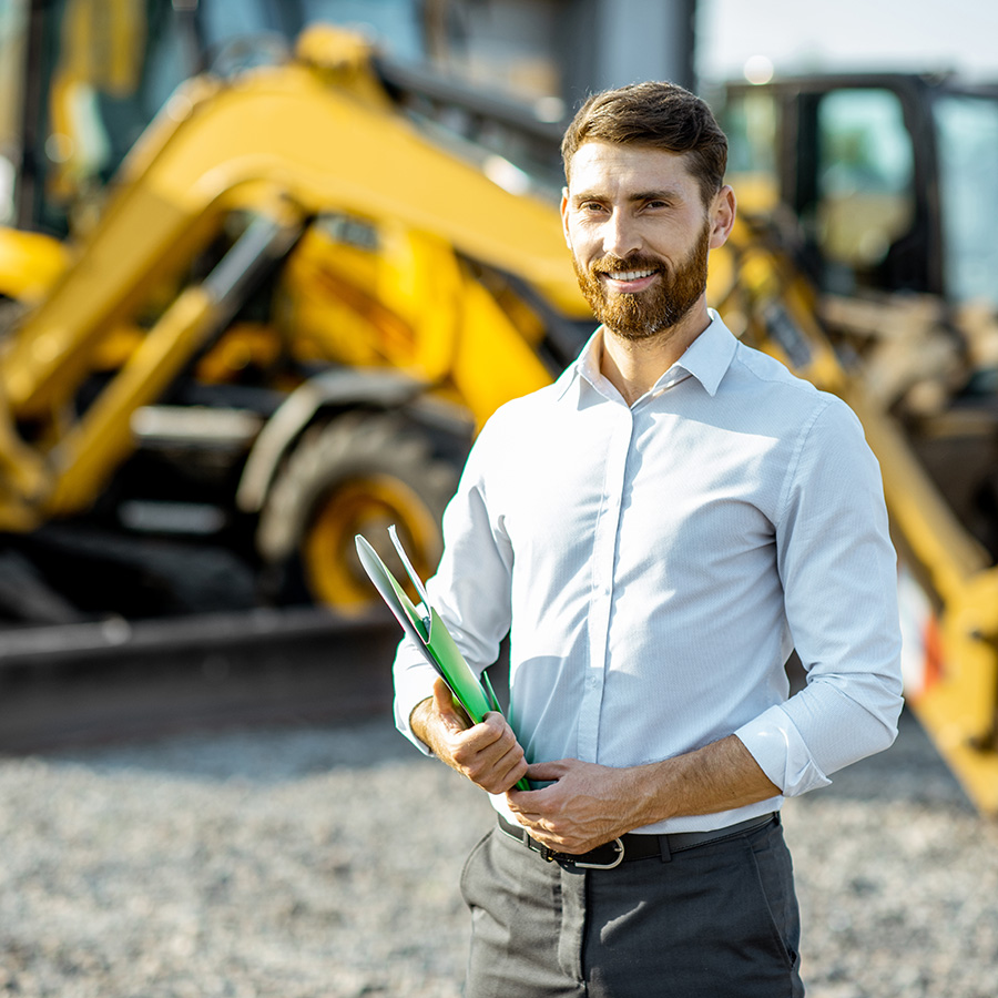salesman at the shop with heavy machinery - Rochford Machinery